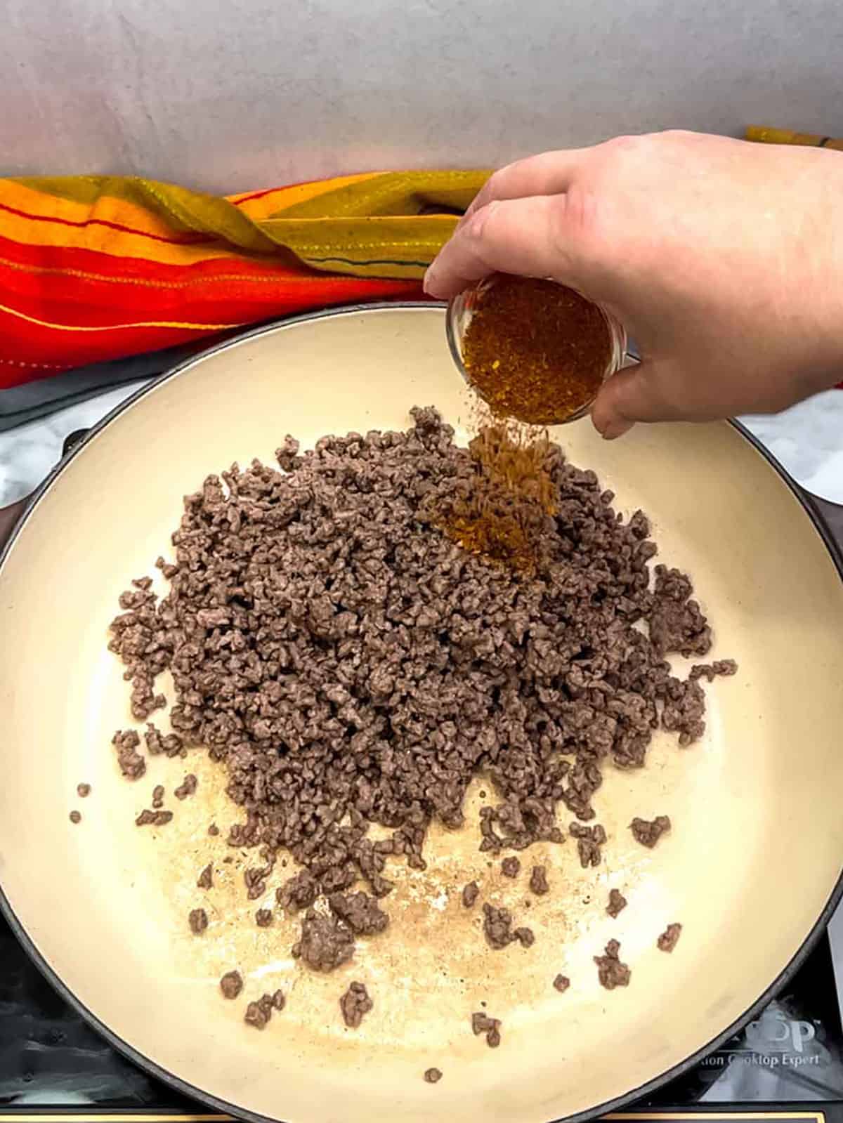 adding taco seasoning