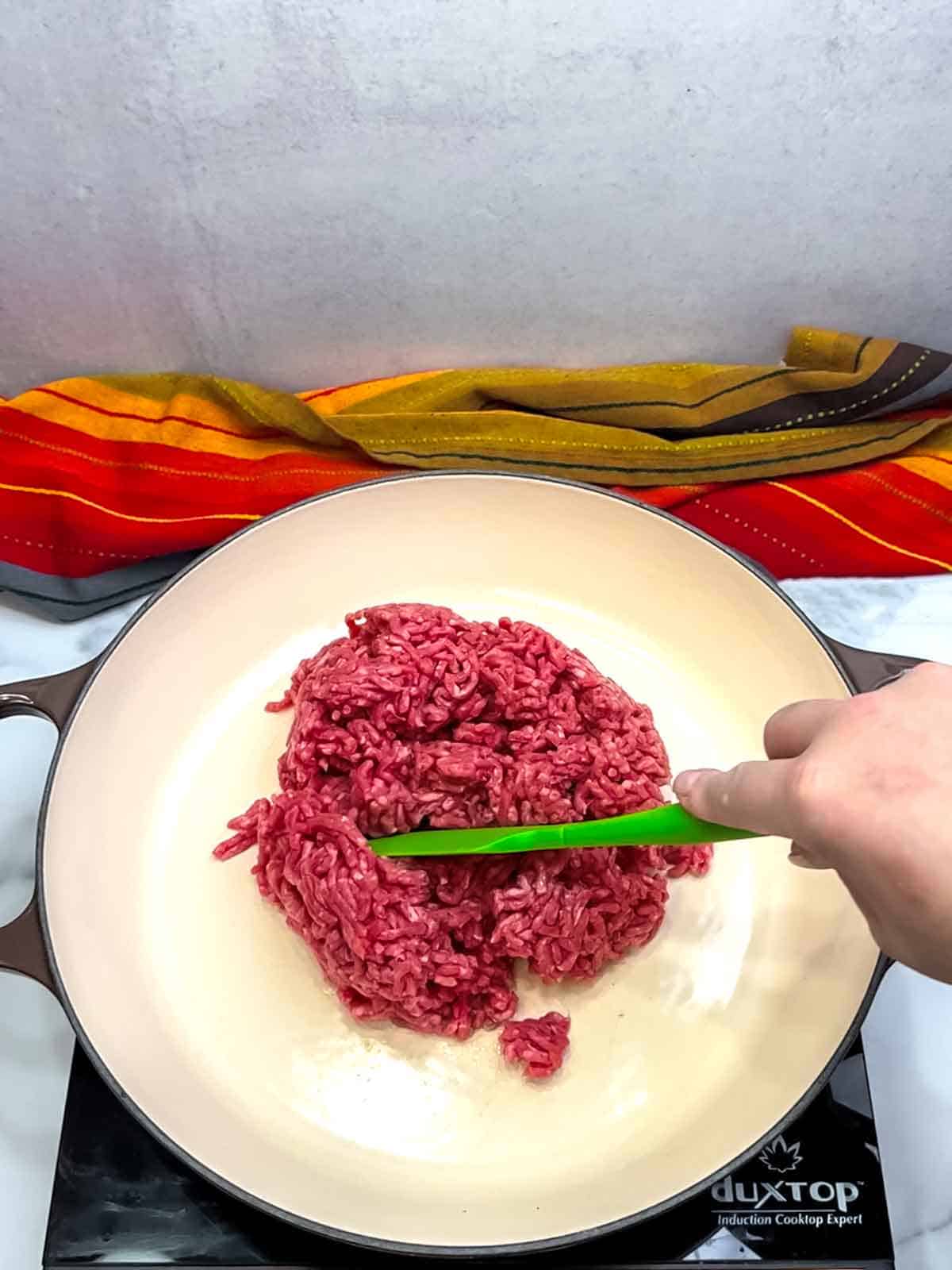 adding ground beef to skillet