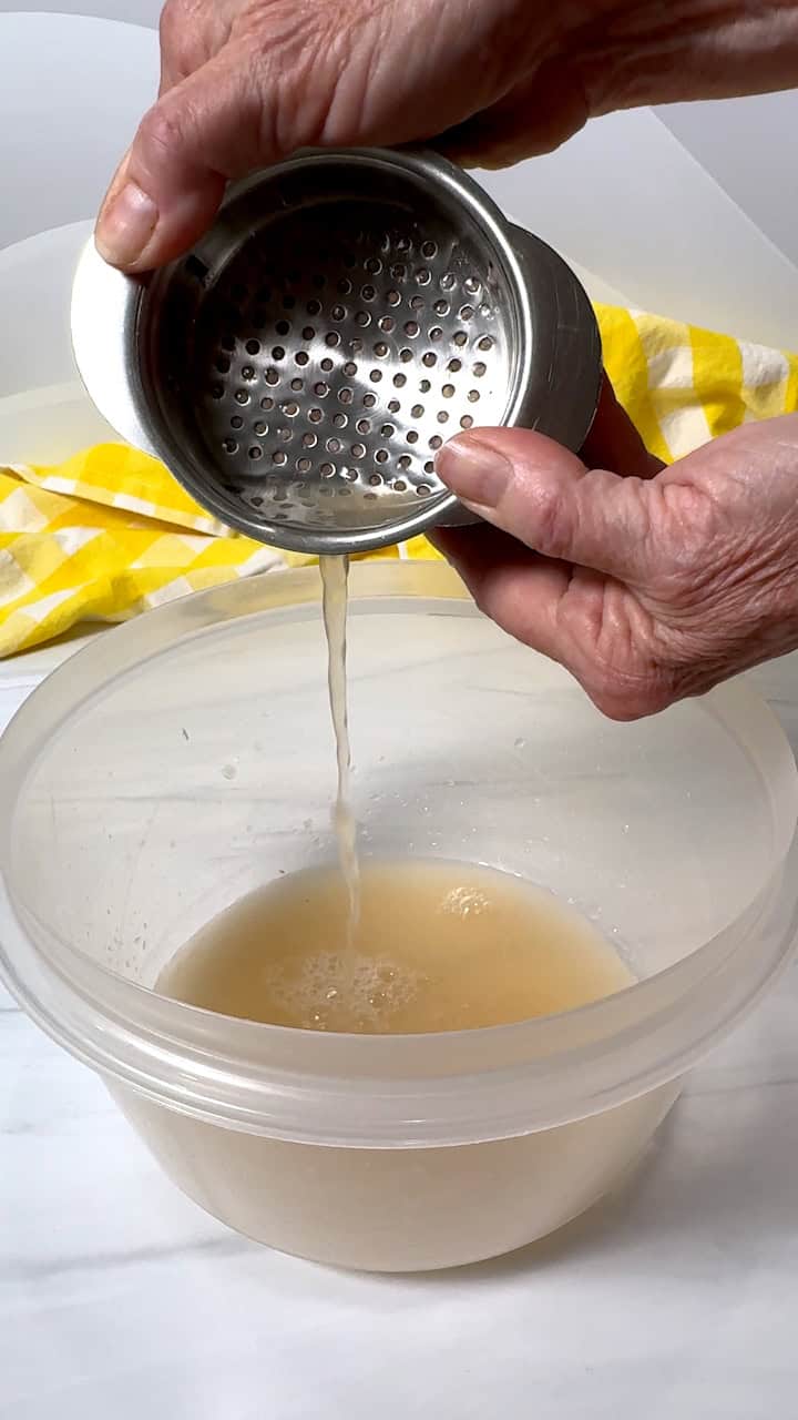 Draining water from cans of tuna.