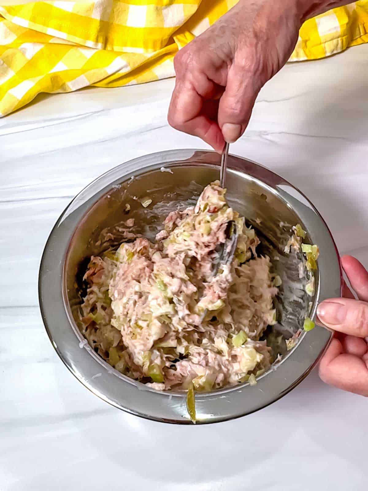 Stirring all of the tuna salad ingredients together.