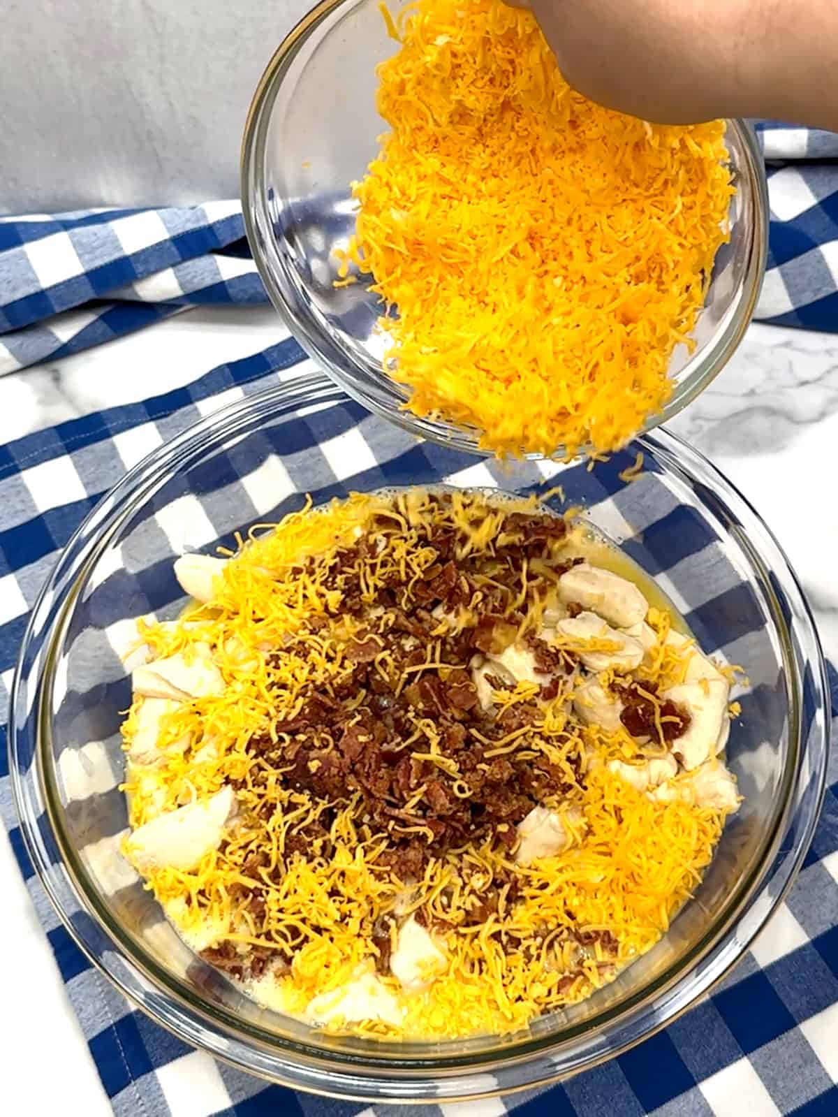 adding bacon and shredded cheese