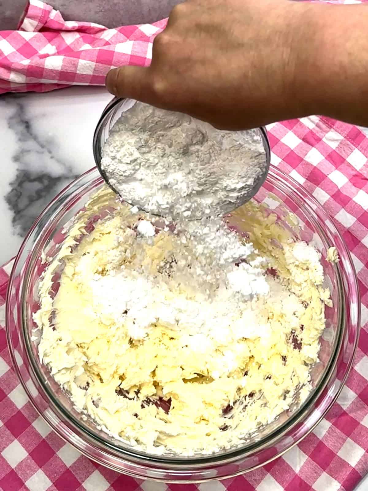 adding powdered sugar for frosting