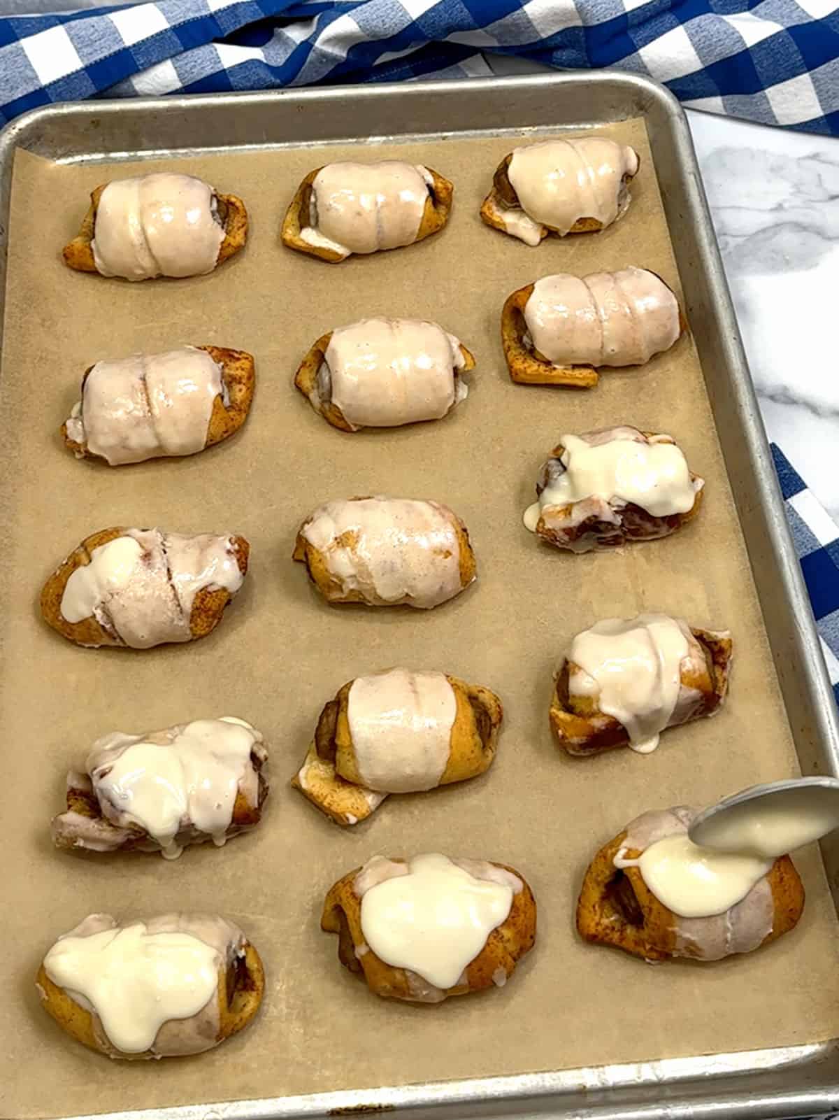 glazing cinnamon roll pigs in a blanket