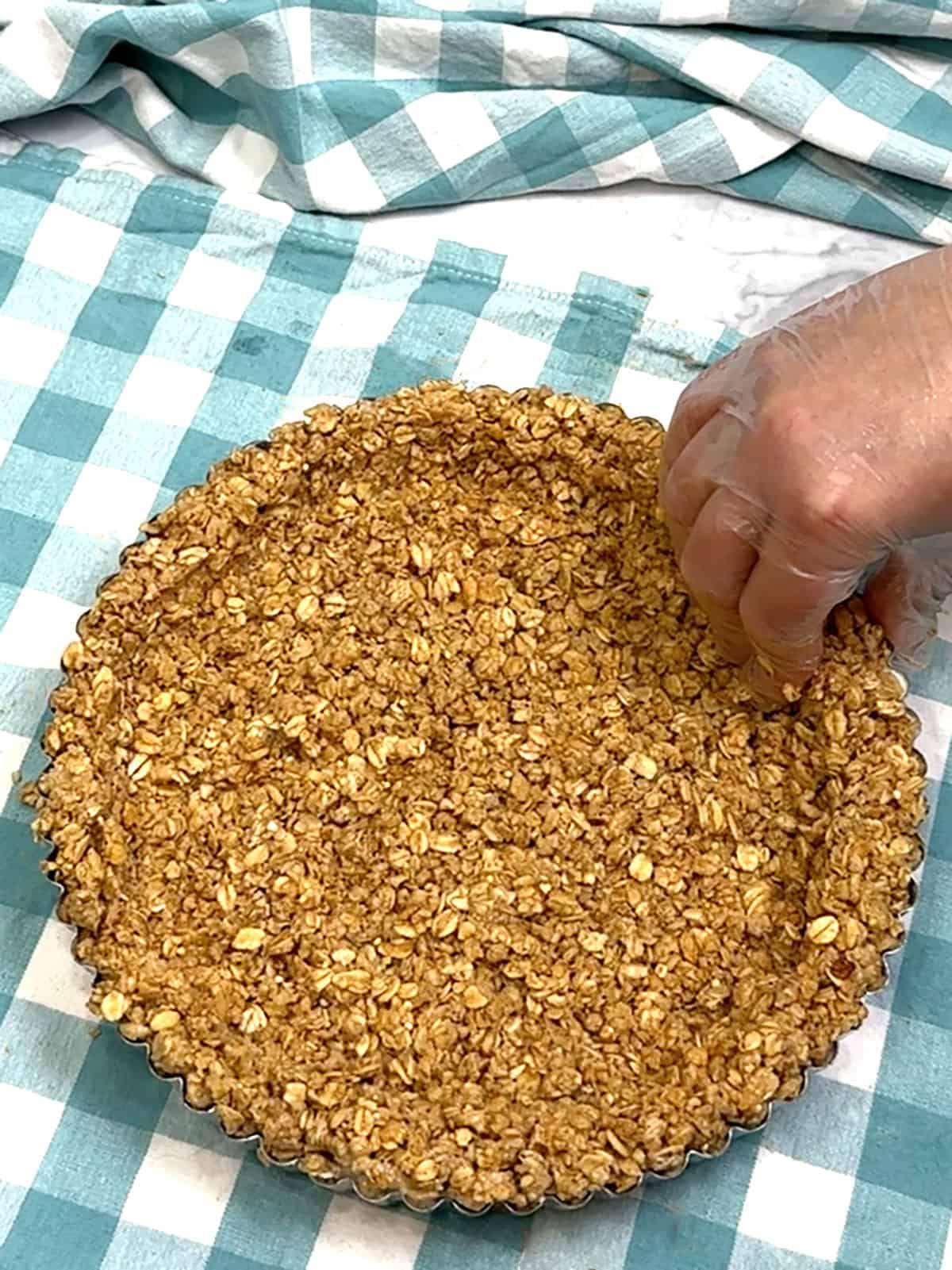 pressing crust into pan