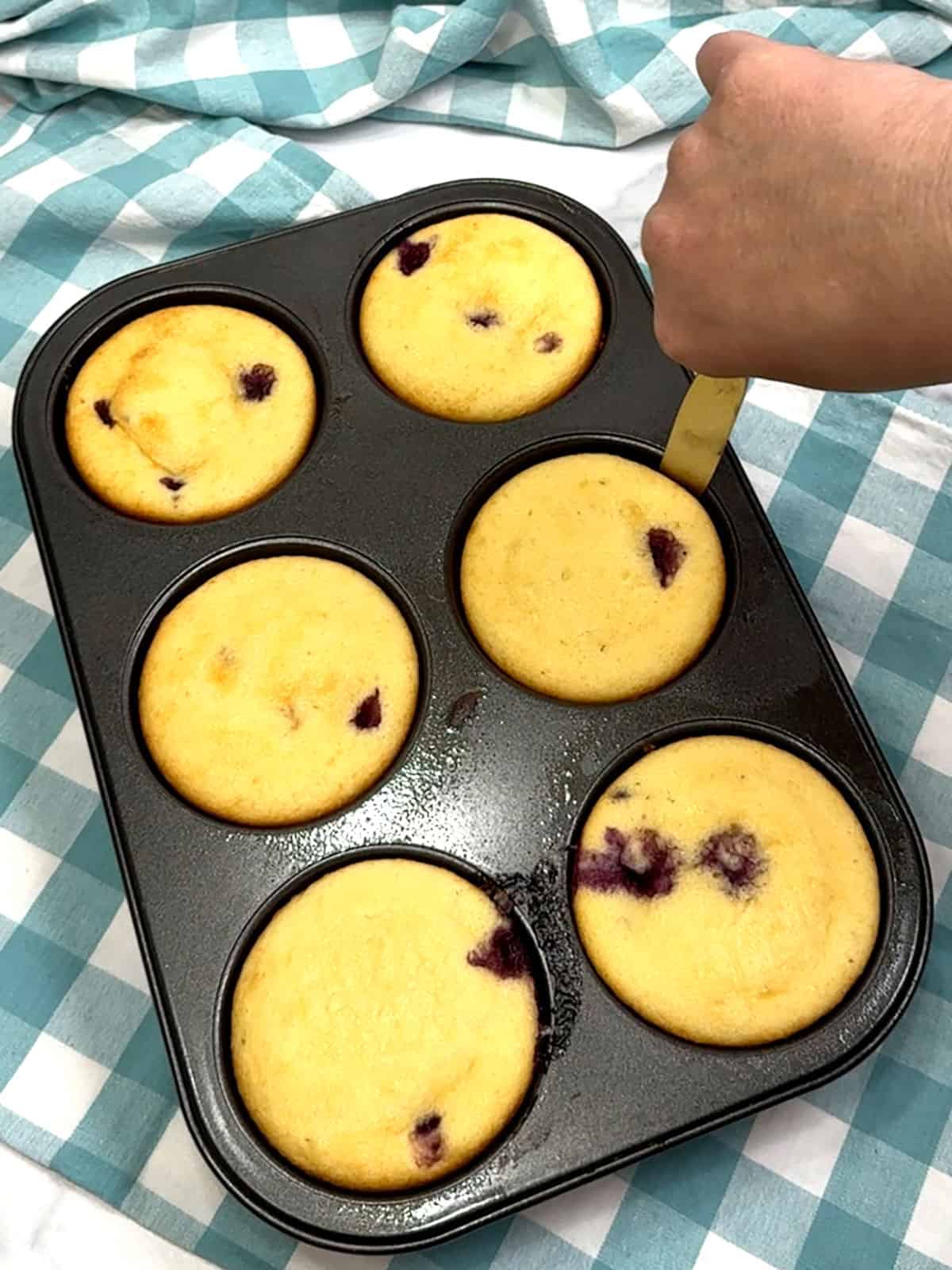 running knife around cakes in pan