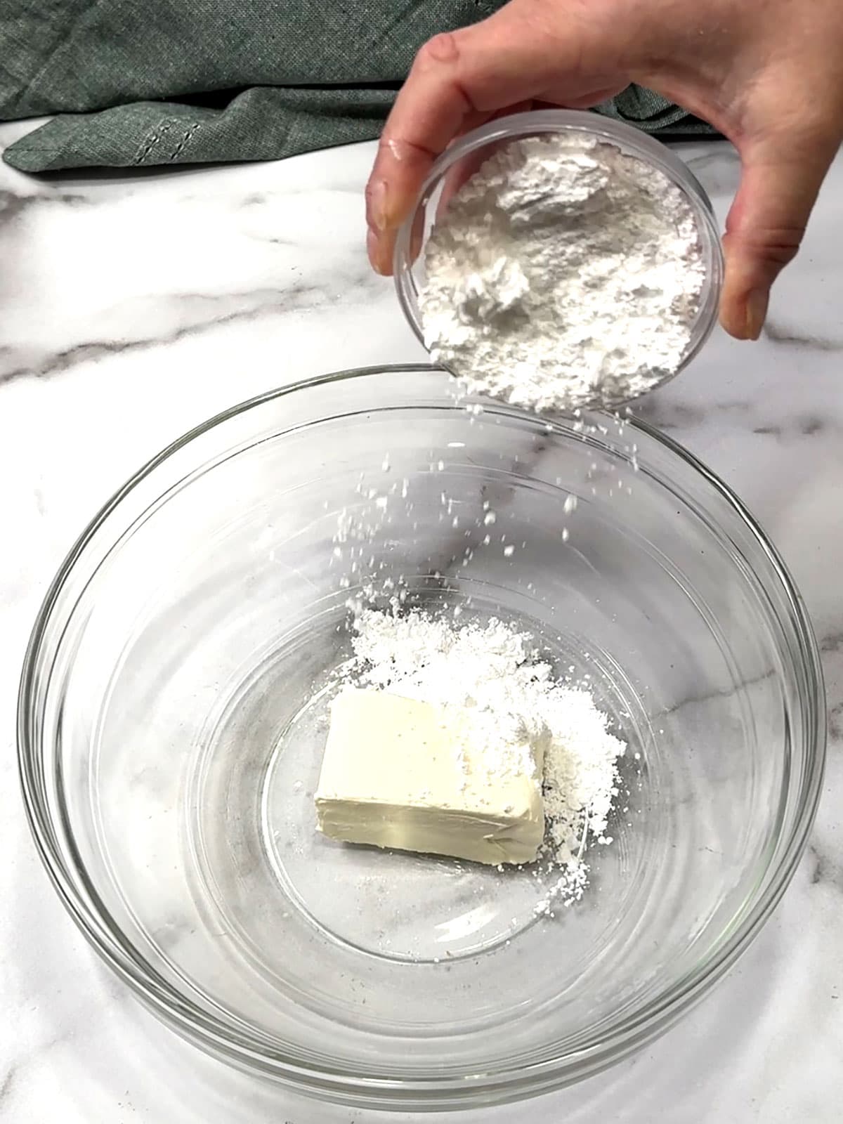 adding powdered sugar to cream cheese for frosting
