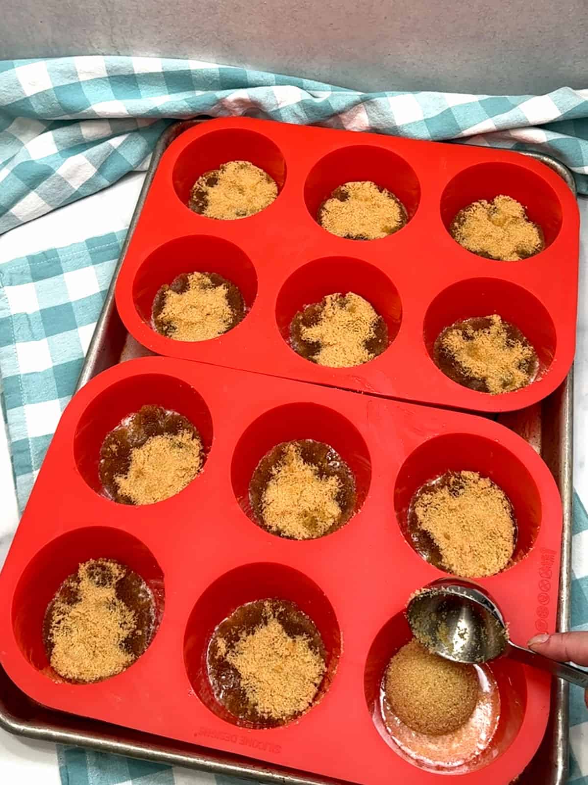 adding brown sugar on top of melted butter in pan