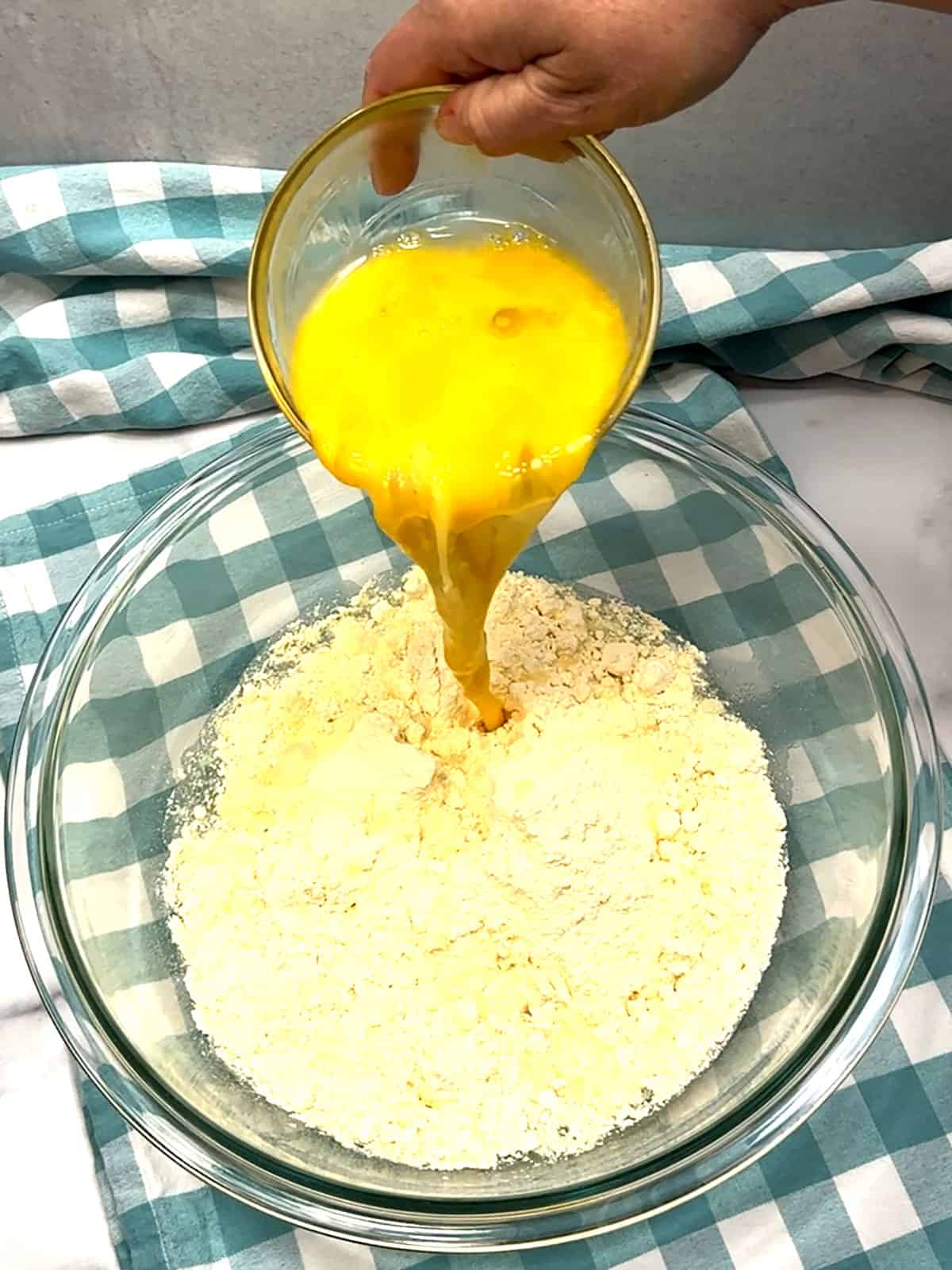 adding beaten eggs to cake mix