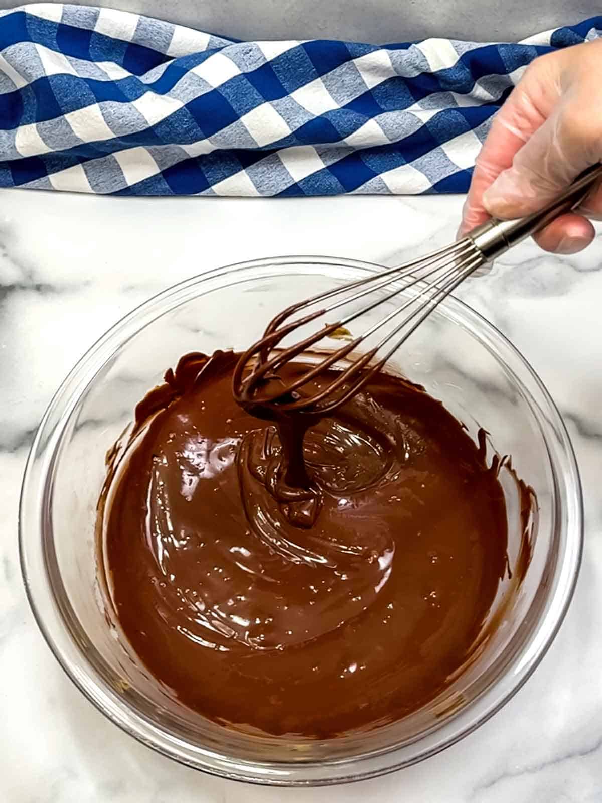 stirring melted chocolate and peanut butter