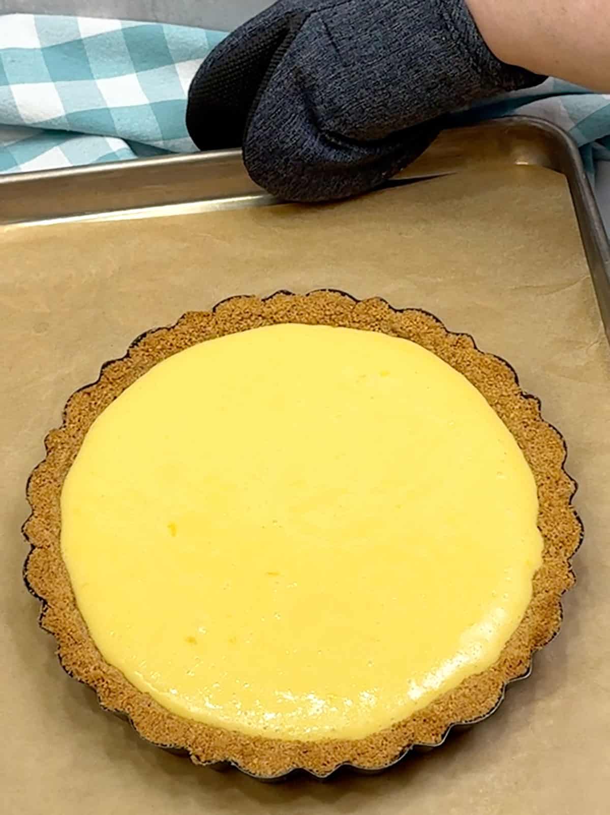 removing classic key lime pie from the oven