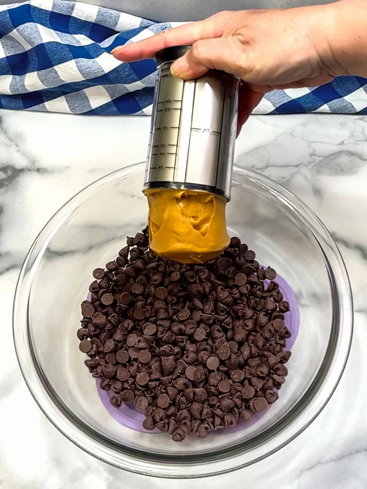 placing chocolate chips and peanut butter into bowl