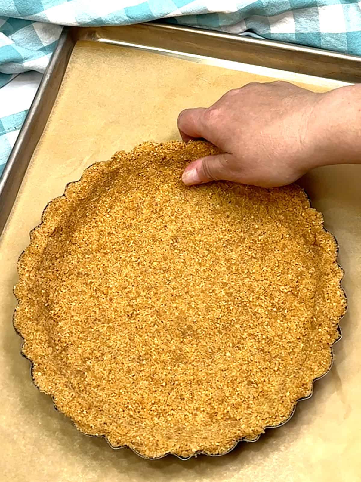 pressing crust into pan