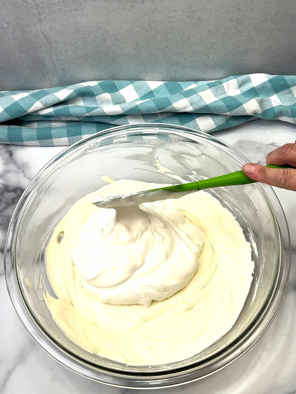 adding whipped cream to filling
