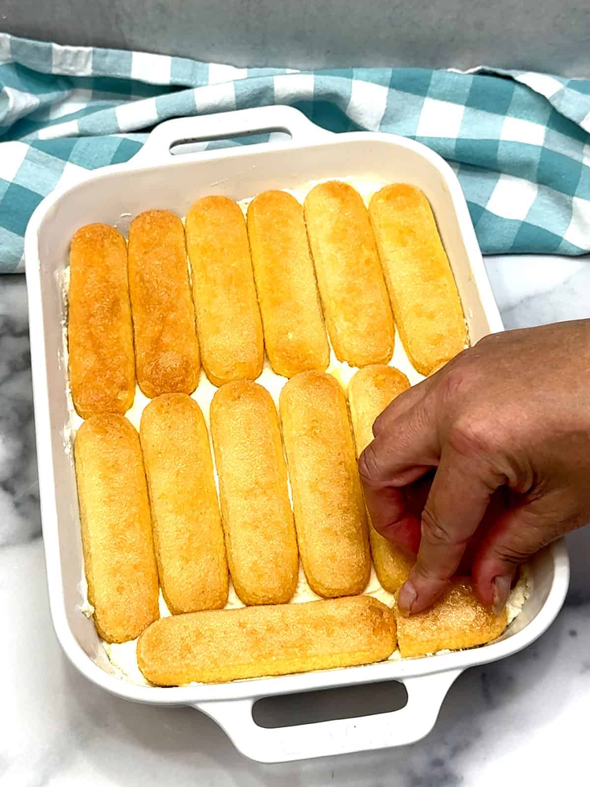 adding top layer of dipped ladyfingers
