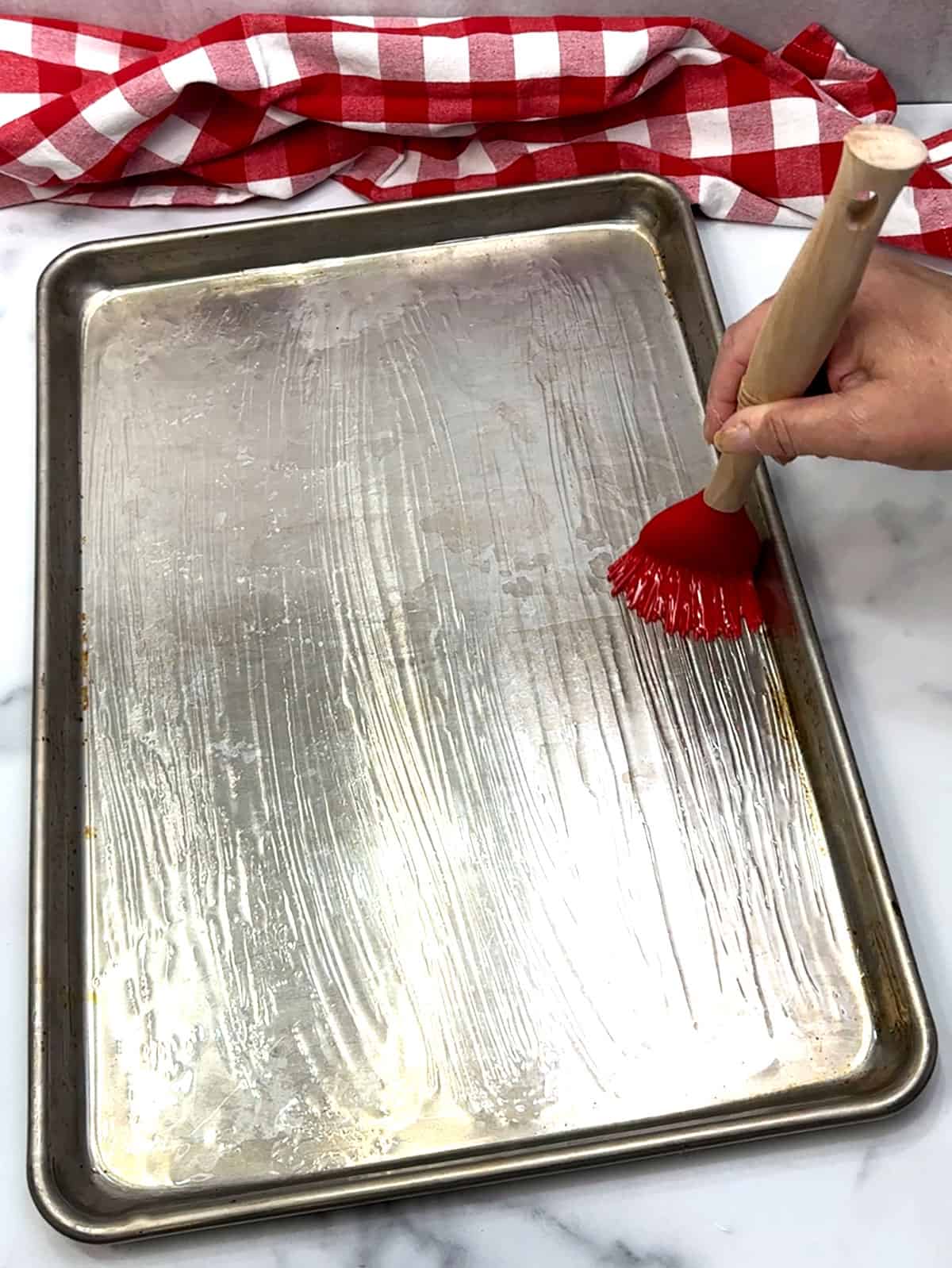 brushing sheet pan with oil