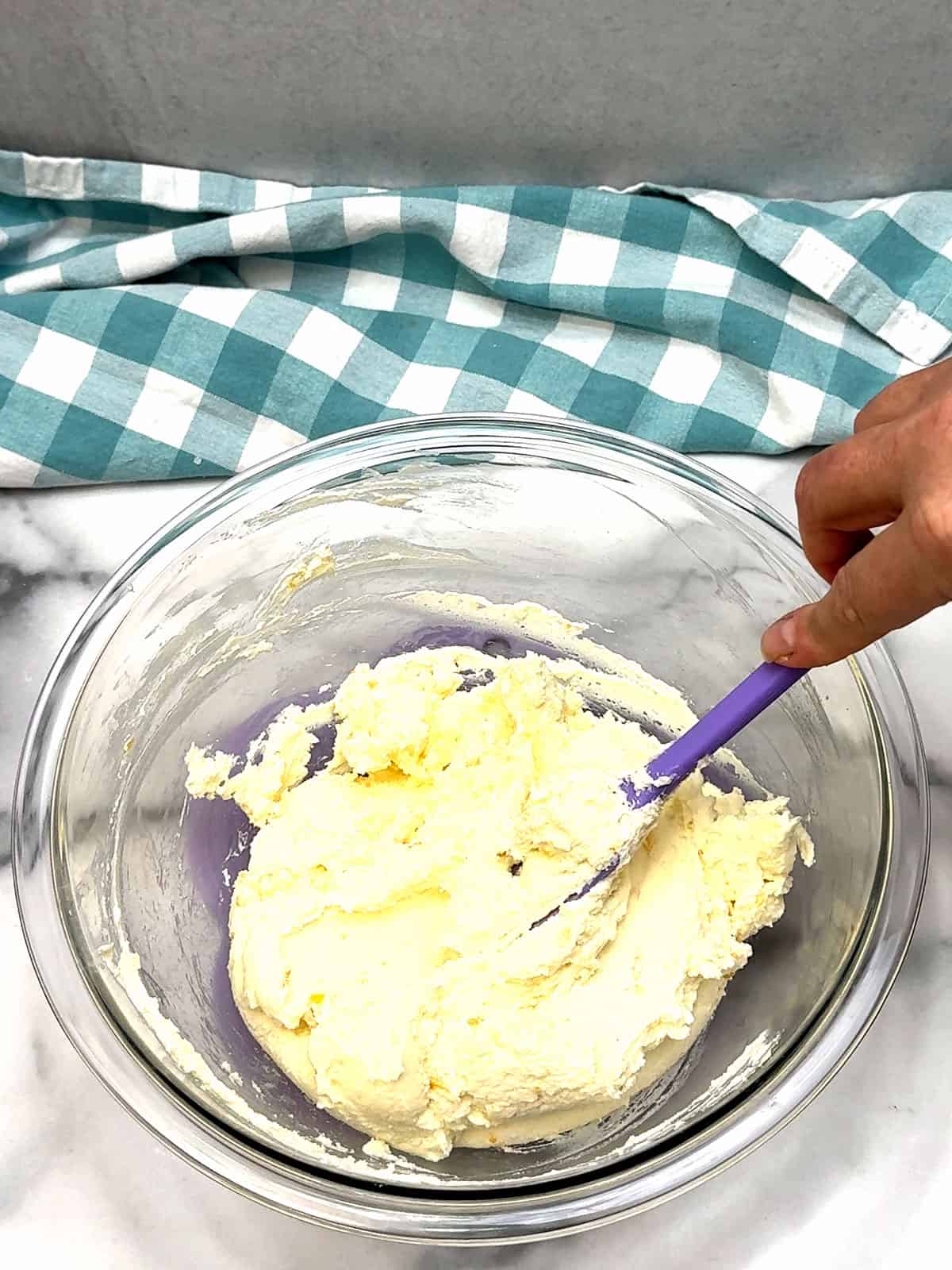 folding lemon peel into mascarpone mixture