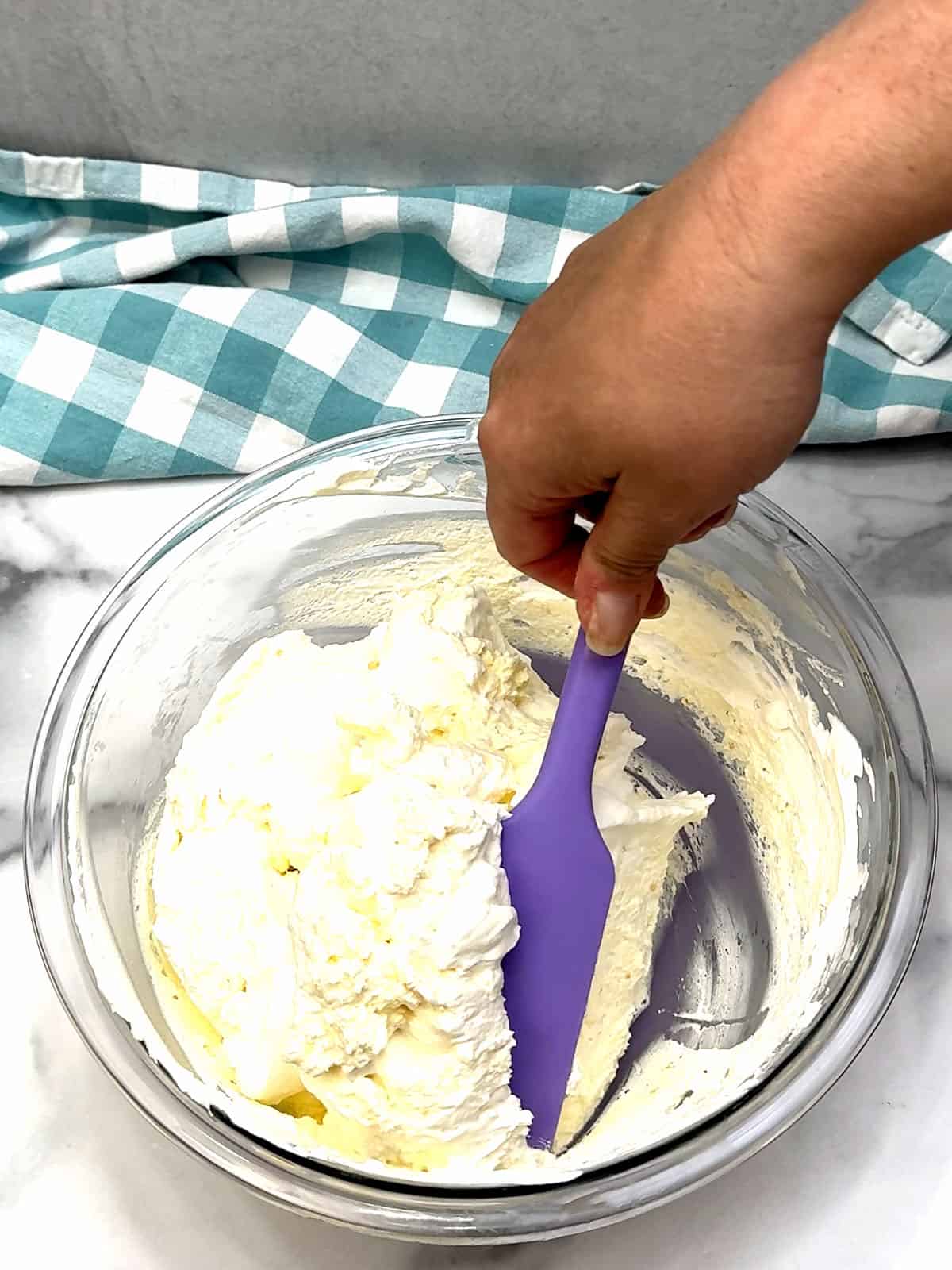 folding whipped cream into mascarpone mixture