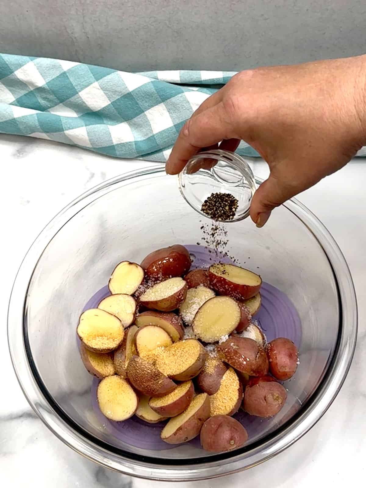 adding spices to potatoes