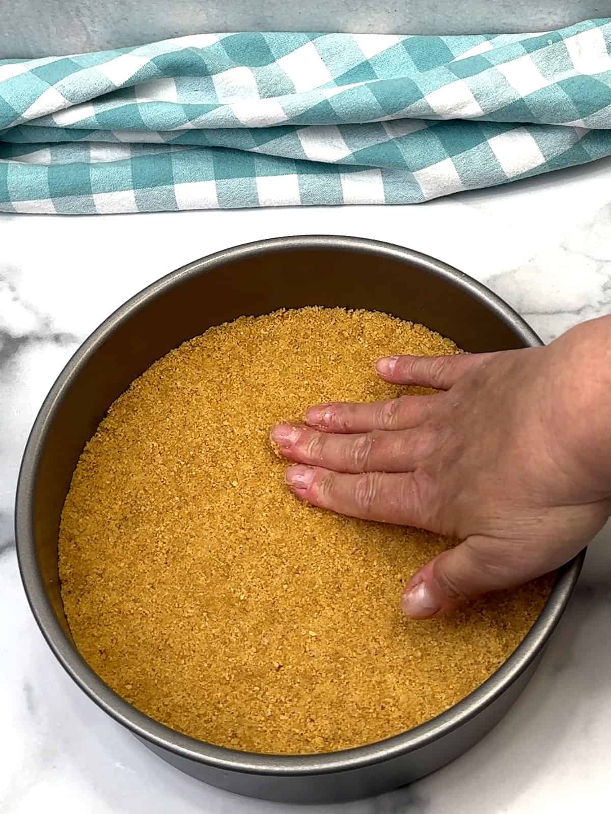 pressing crust into pan