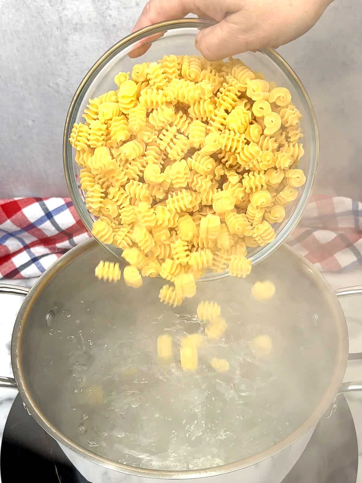 Adding dry paste to water to cook