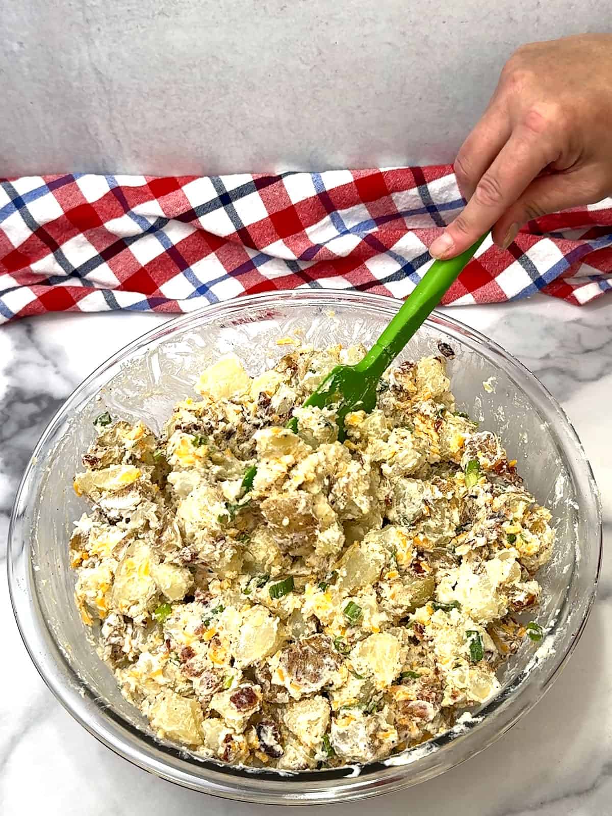 stirring loaded baked potato salad