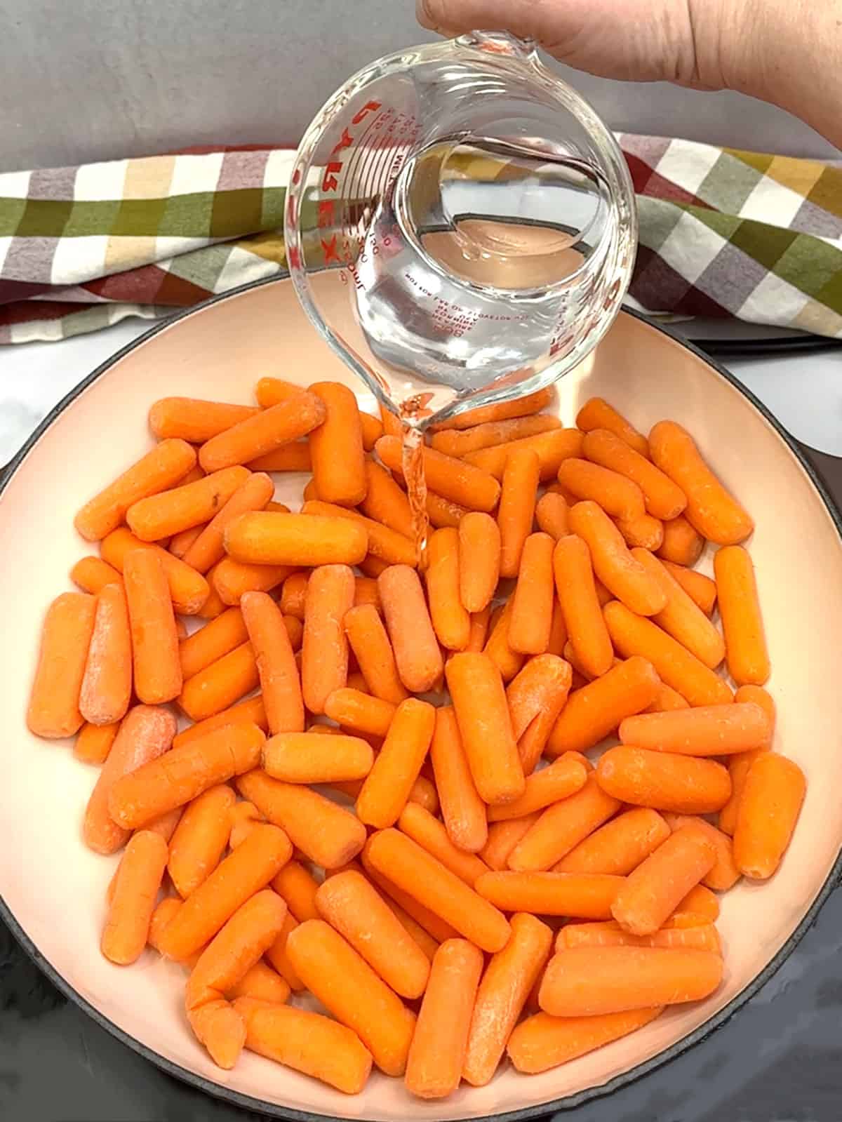 adding water to carrots