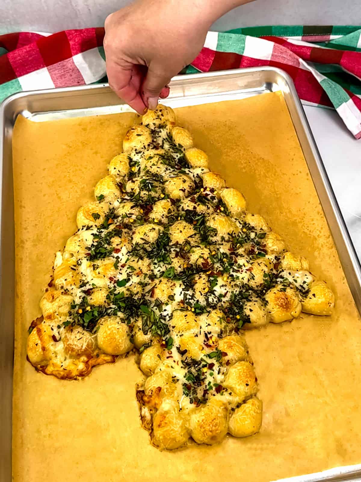 toping with fresh herbs and red pepper flakes