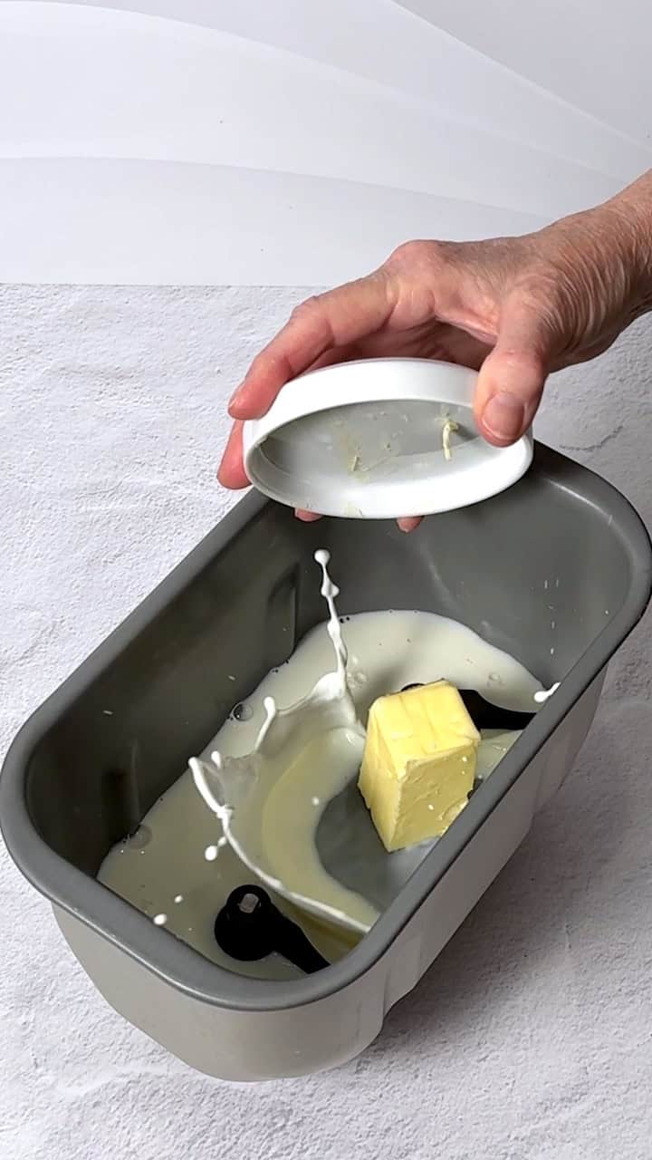 Adding butter to the bread machine.