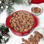 Candied almonds in a a red dish.