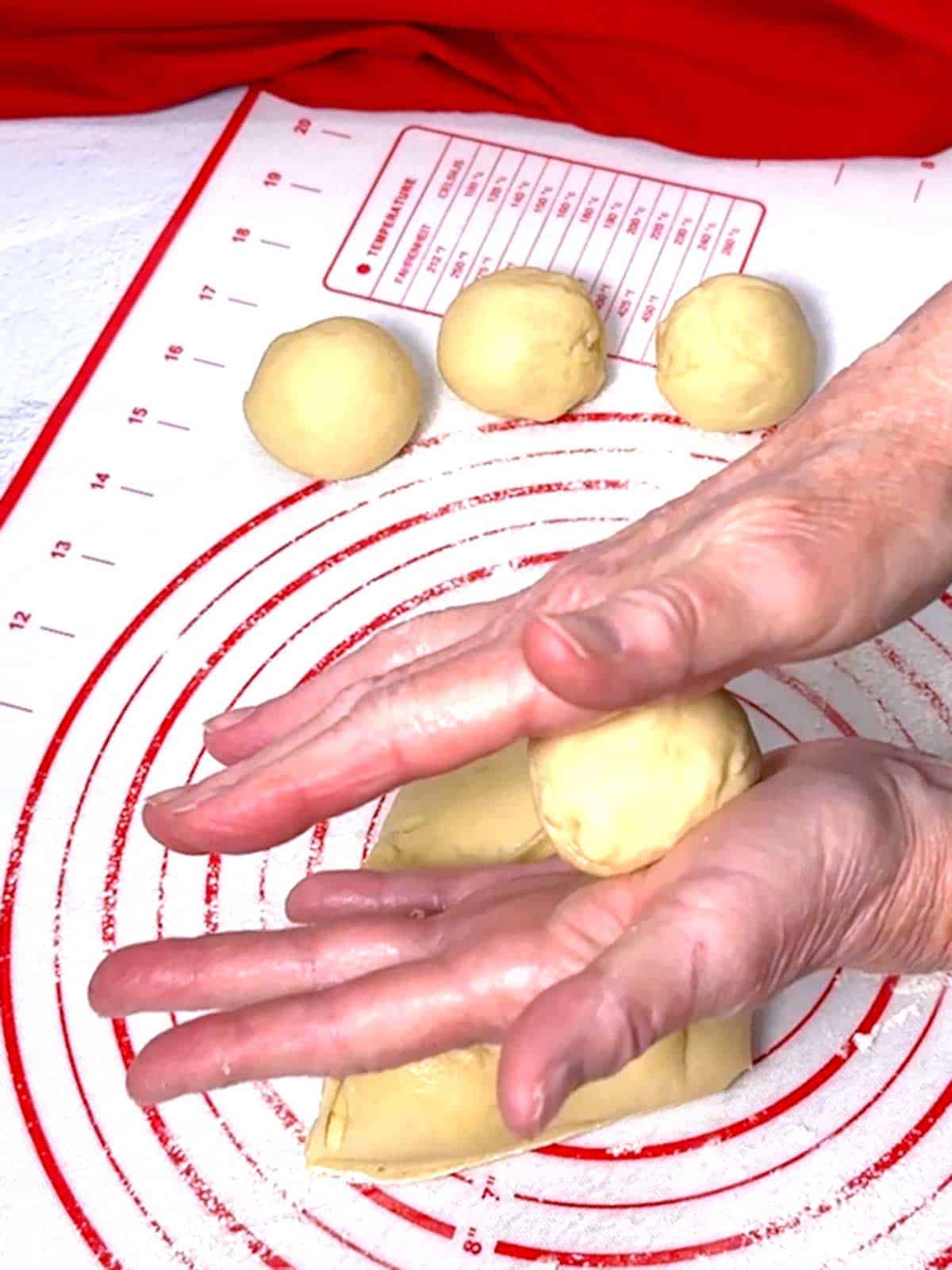 Rolling the dough into a smooth ball.