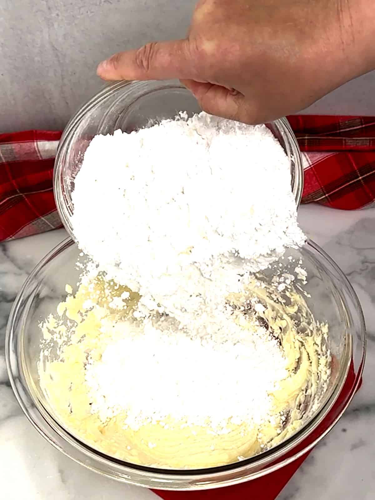 adding powdered sugar for frosting