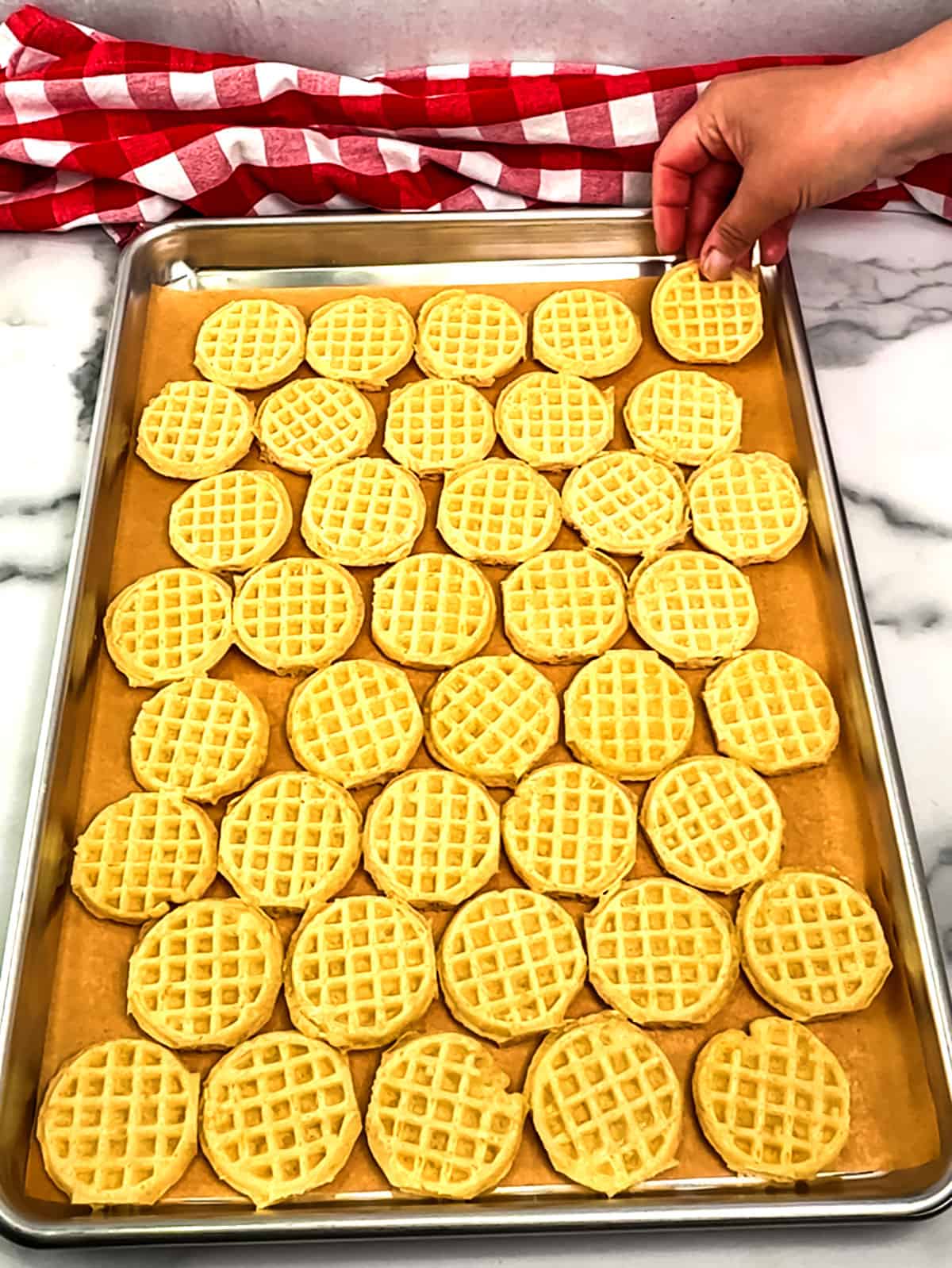 placing mini waffles on pan
