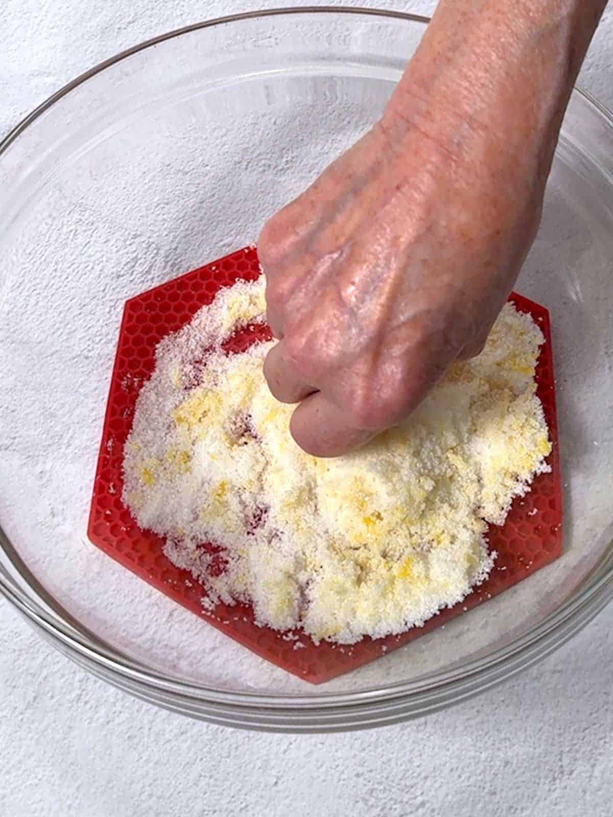 Rubbing the lemon zest into the sugar.