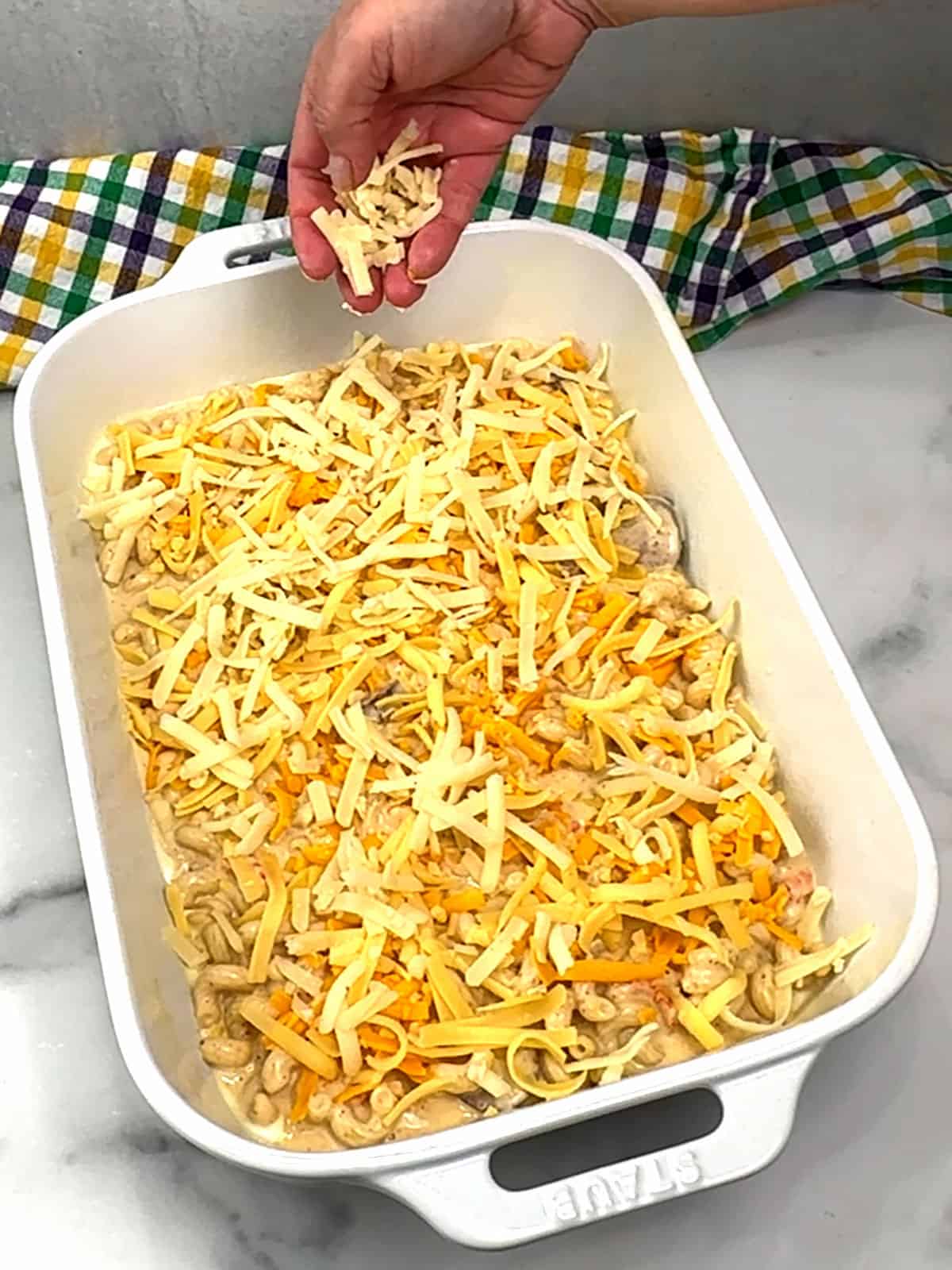 sprinkling middle layer of cheese into baking dish