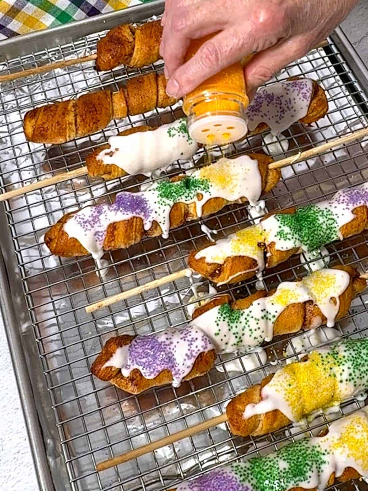 Decorating the King Cakes on a Stick.