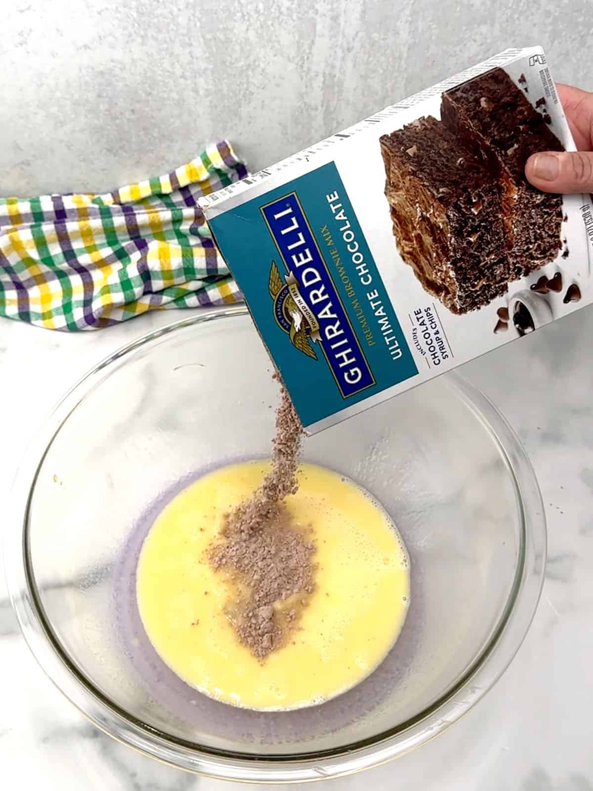 adding brownie mix to the bowl