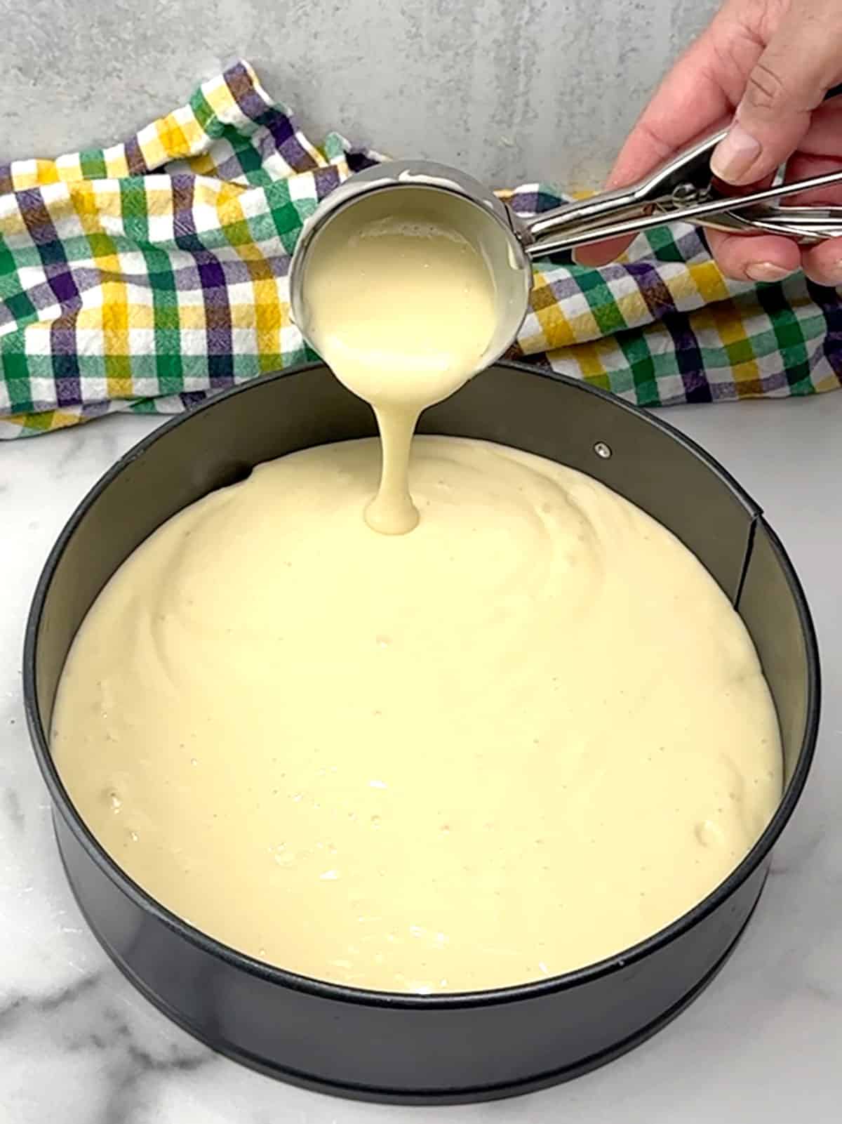 adding cheesecake filling to pan
