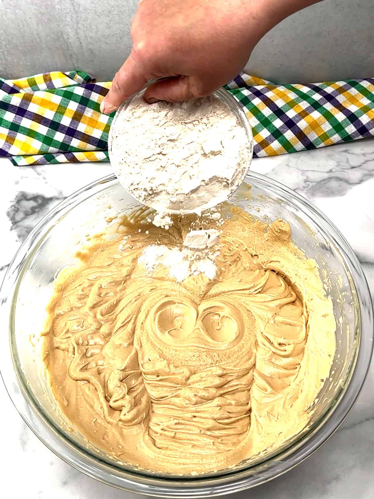 adding dry ingredients to cake batter