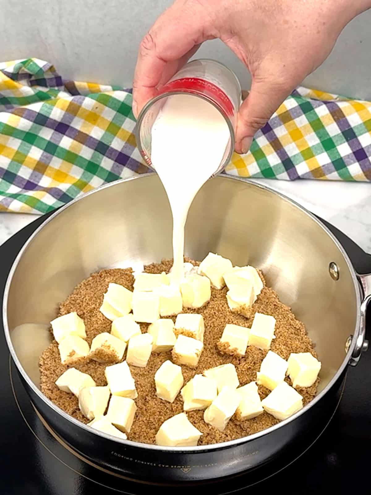 adding milk to dark brown sugar and unsalted butter for praline icing 