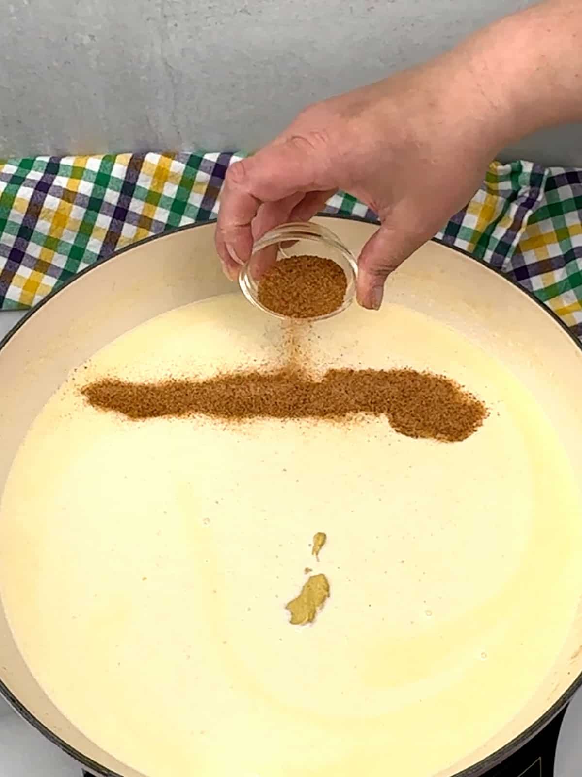 adding mustard and cajun seasoning