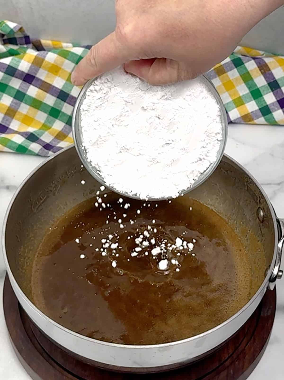 adding vanilla and powdered sugar for praline icing
