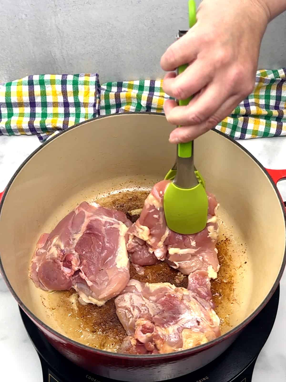 adding chicken thighs to dutch oven