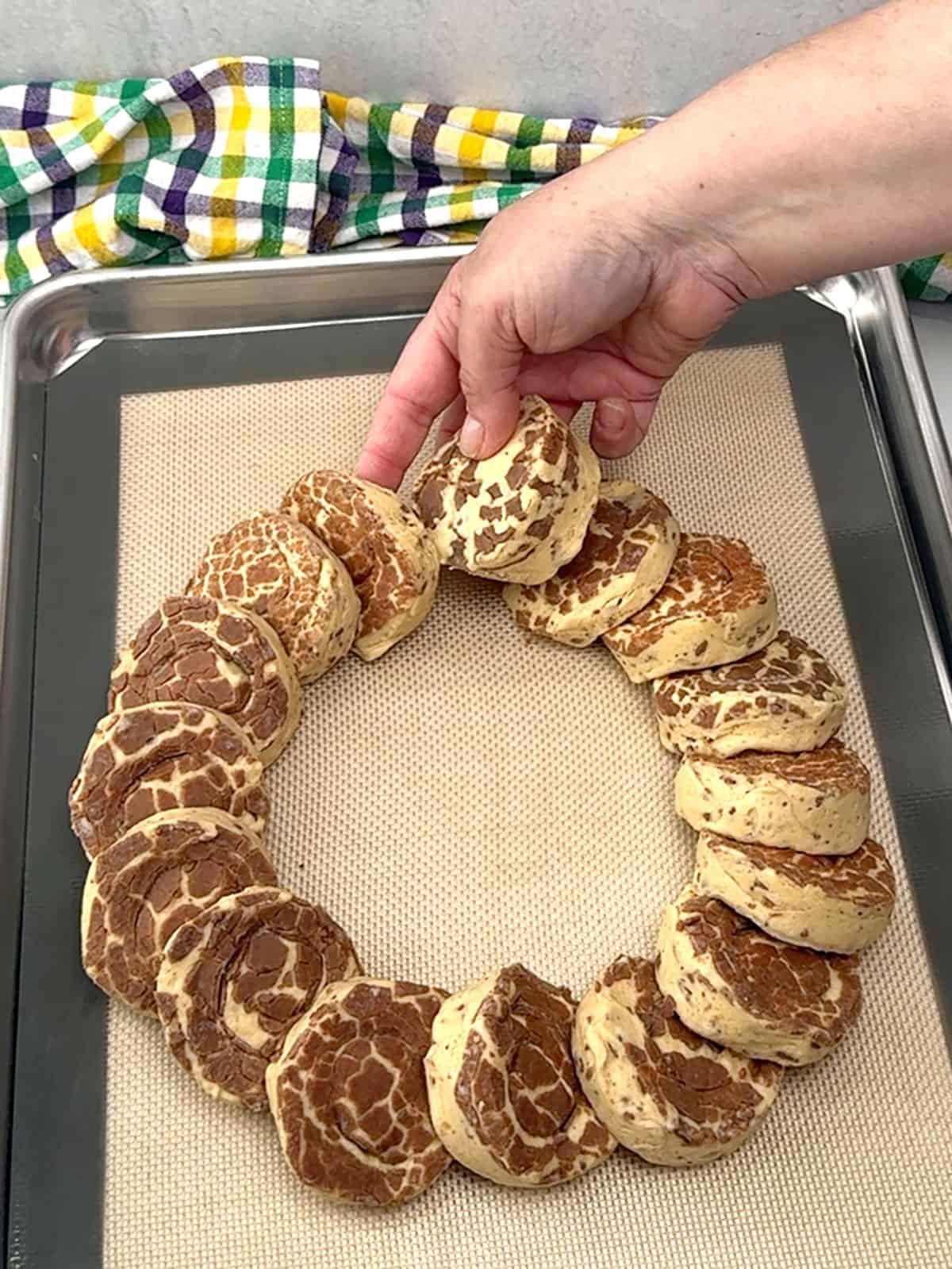 placing cinnamon rolls on pan