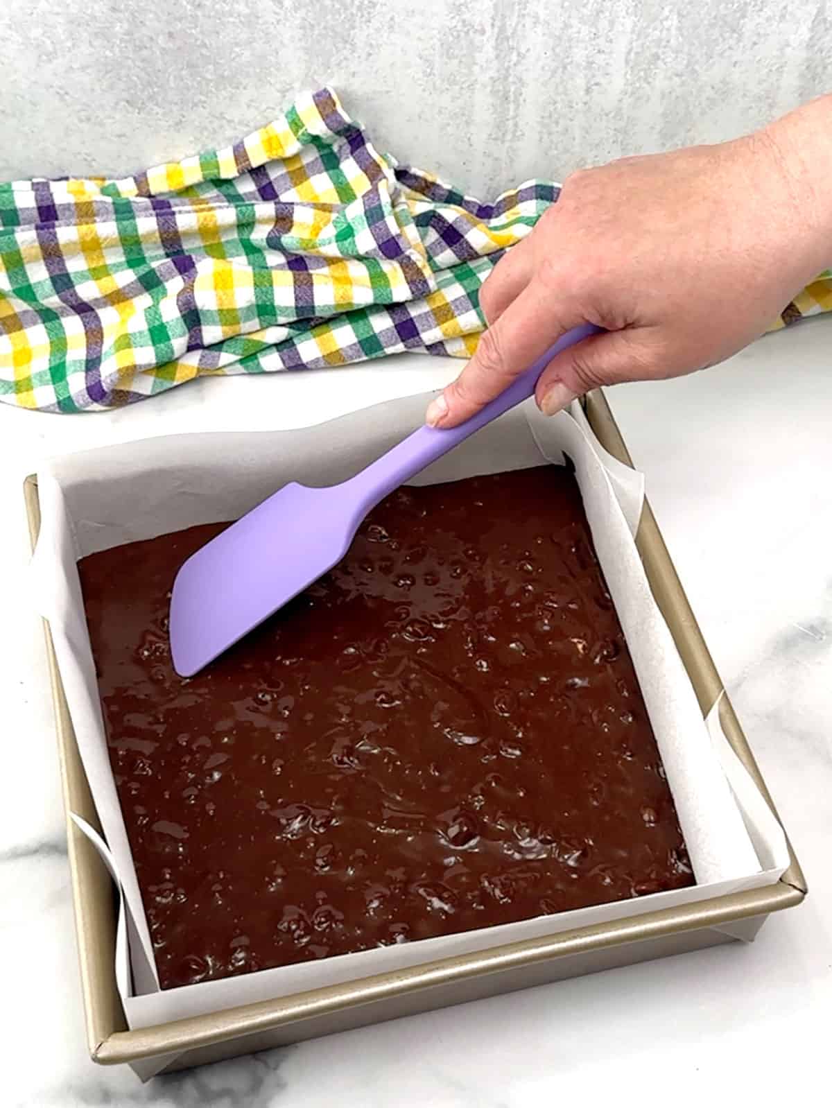 smoothing brownies in pan