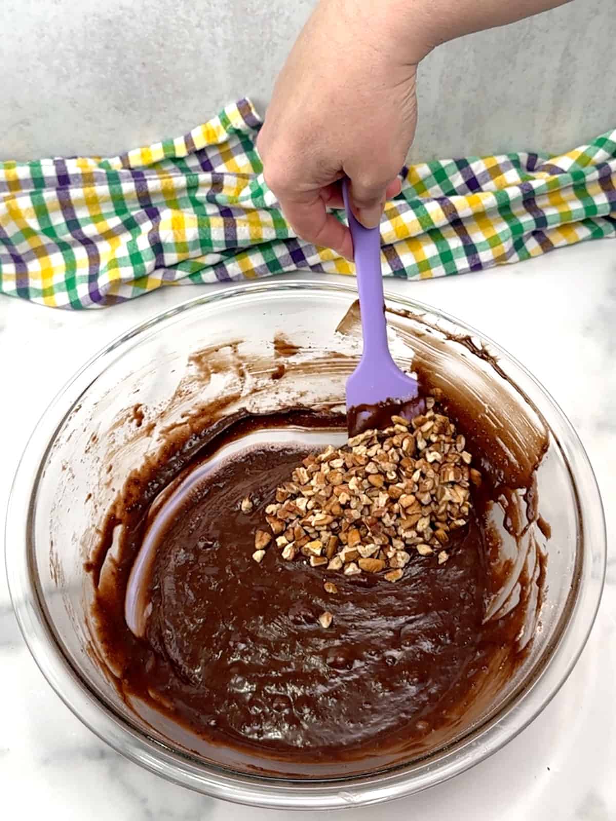stirring pecans into brownies
