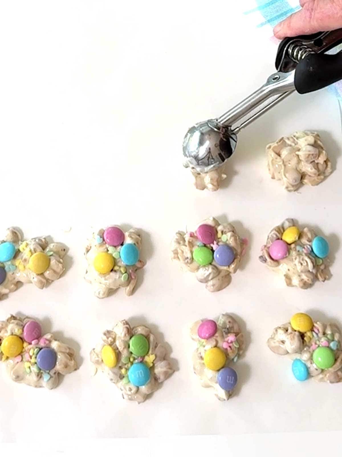 Using an ice cream scoop to portion the candy.