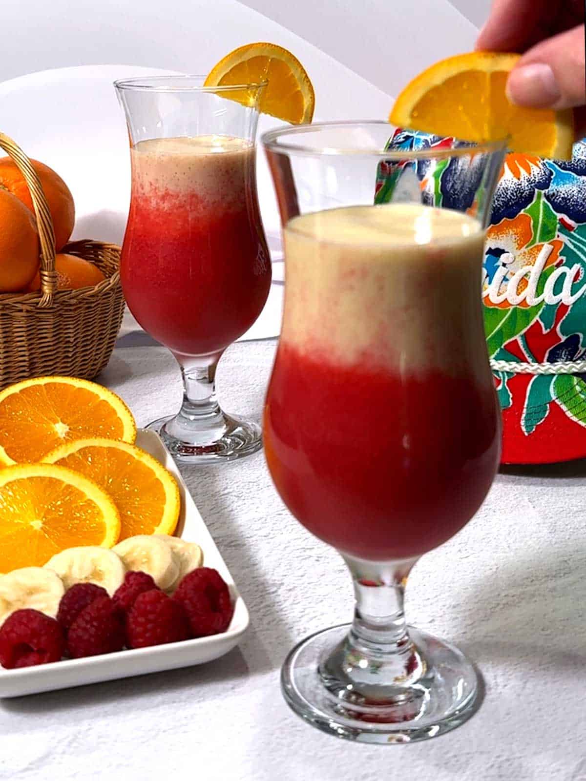 Placing an orange slice on the rim of the glass.