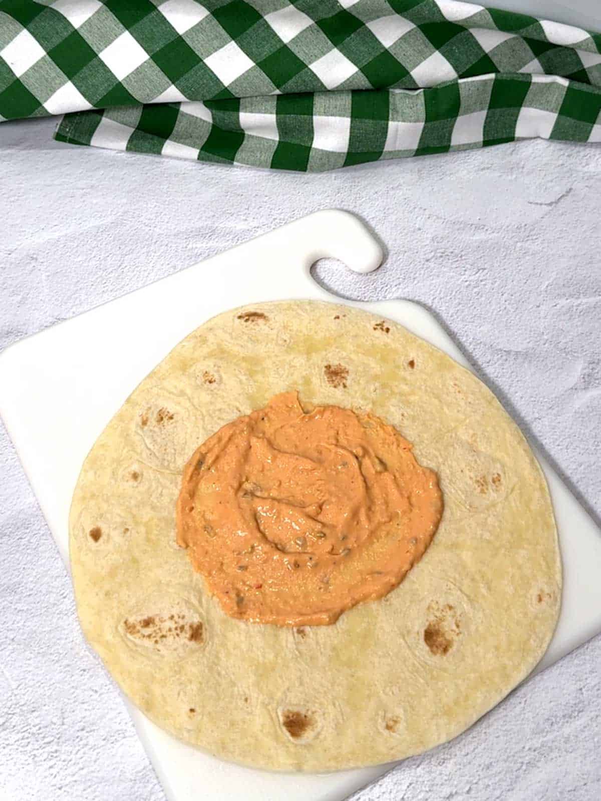 Thousand Island dressing spread on a 10-inch flour tortilla.