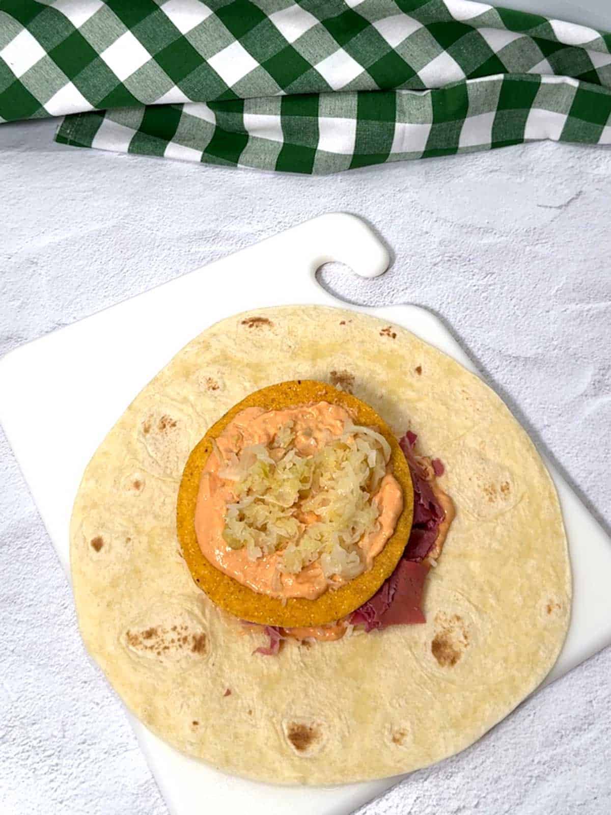 Sauerkraut added to the crunchwrap.