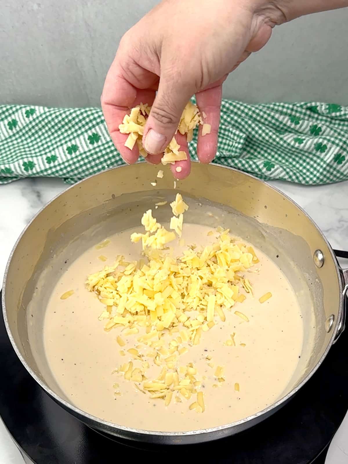 adding shredded cheese